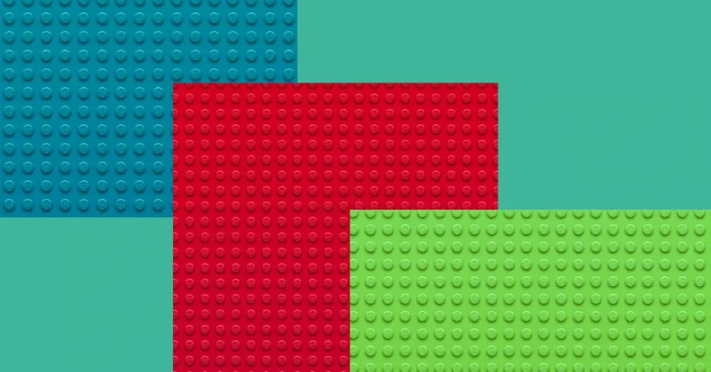 3 different colors of 16 x 16 lego baseplates.